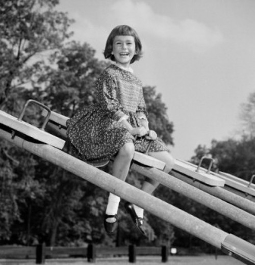 Girl sitting on seesaw laughing Poster Print - Item # VARSAL255418563