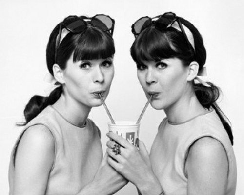 Portrait of twin young women drinking cold drink Poster Print - Item # VARSAL25544389