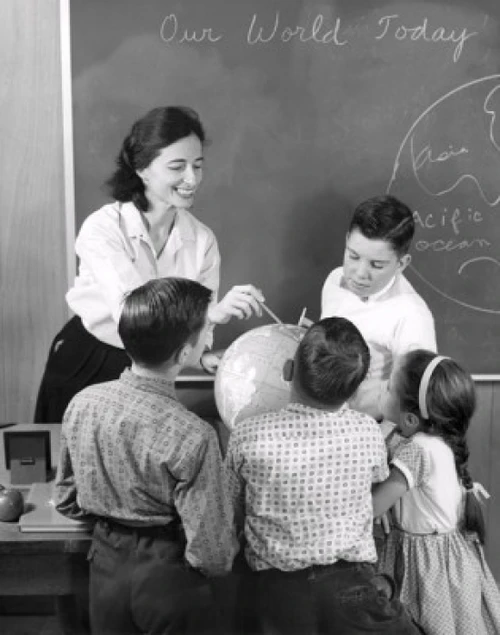 Female teacher and her students looking at a globe Poster Print