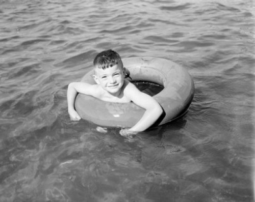 Boy swimming in inflatable ring Poster Print - Item # VARSAL255421877