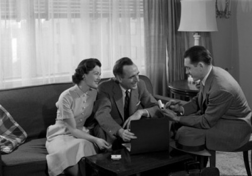 Couple talking with advisor in living room Poster Print - Item # VARSAL25527971