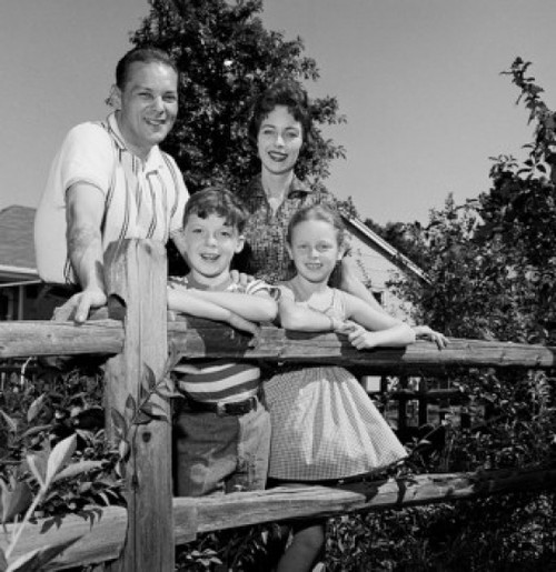Portrait of parents and kids leaning on farm fence Poster Print - Item # VARSAL255417566