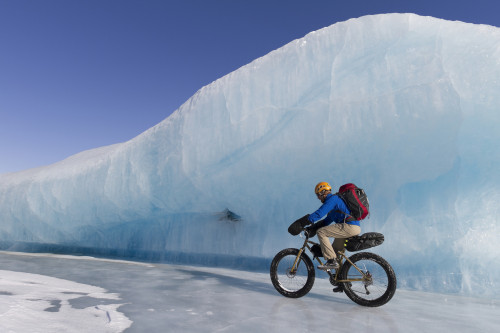 Man Fat Tire Mountain Biking On Ice At The Knik Glacier, Chugach Mountains, Southcentral Alaska, Winter PosterPrint - Item # VARDPI2097876
