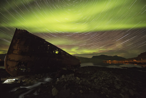 Star trails and northern lights over top the town of Djupavik in the West Fjords of Iceland; Djupavik, Iceland PosterPrint - Item # VARDPI12296385