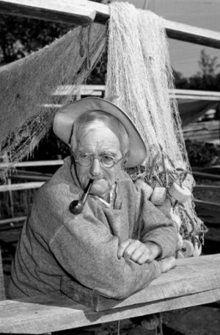 Portrait of fisherman with pipe  fishing net in the background Poster Print - Item # VARSAL2555956