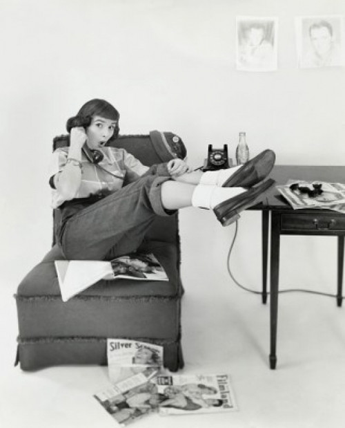 Teenage girl sitting on a chair and talking on the phone Poster Print - Item # VARSAL2554764A