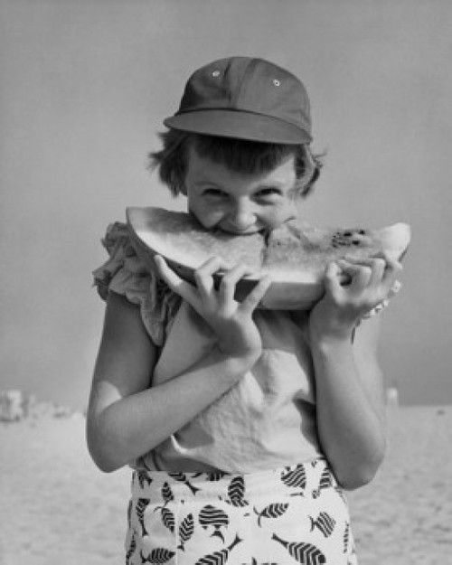 Portrait of girl eating watermelon on beach Poster Print - Item # VARSAL25513941