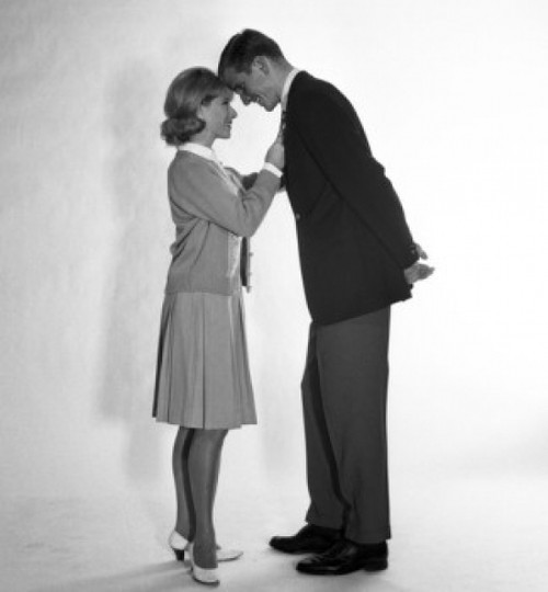 Mid adult couple standing face to face and smiling Poster Print - Item # VARSAL255418019