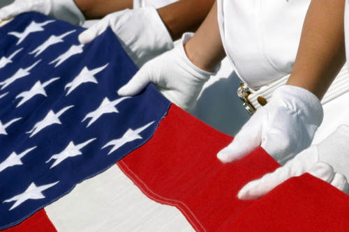 Pearl Harbor, Hawaii, August 30, 2003 - A Naval Station Pearl Harbor Ceremonial Guard folds the National Ensign during a burial ceremony held aboard the USS Utah Memorial Poster Print - Item # VARPSTSTK101222M