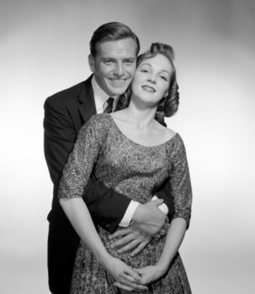 Studio portrait of happy couple embracing Poster Print - Item # VARSAL255417630