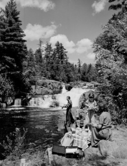 Family with two children having picnic by river Poster Print - Item # VARSAL255424948
