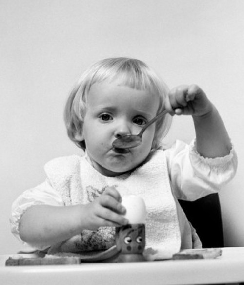 Baby girl with spoon eating egg Poster Print - Item # VARSAL2559694A