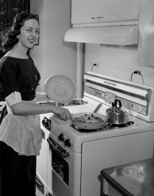 Young woman preparing meal in kitchen Poster Print - Item # VARSAL255416689