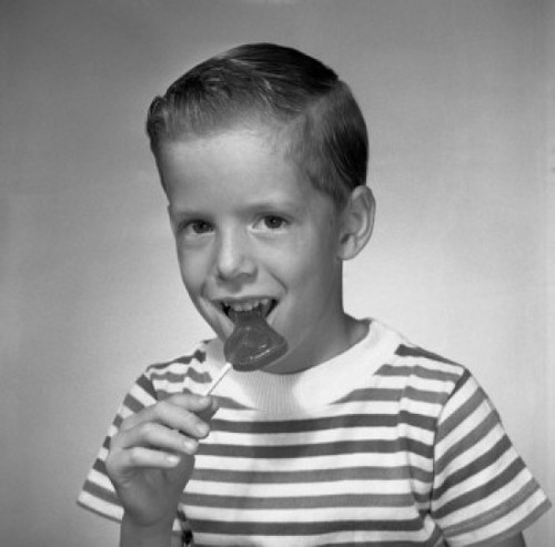 Studio portrait of boy eating lollipop Poster Print - Item # VARSAL255420927