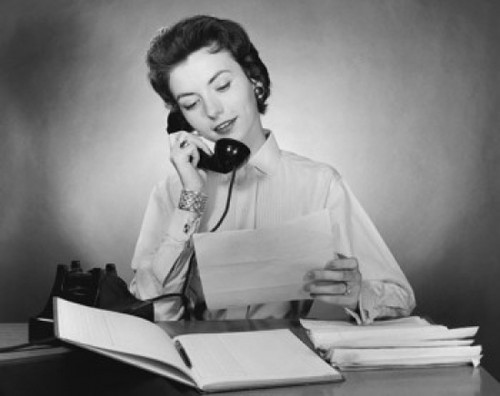 Businesswoman talking on the telephone and holding a document in an office Poster Print - Item # VARSAL25516880