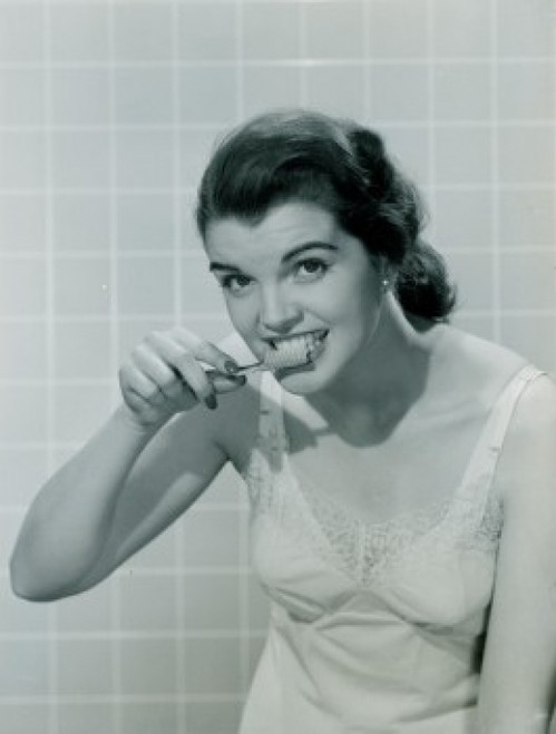 Young woman brushing teeth Poster Print - Item # VARSAL255417230