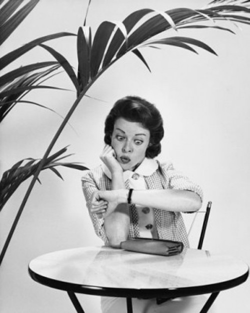 Mid adult woman looking at her wristwatch Poster Print - Item # VARSAL25541914
