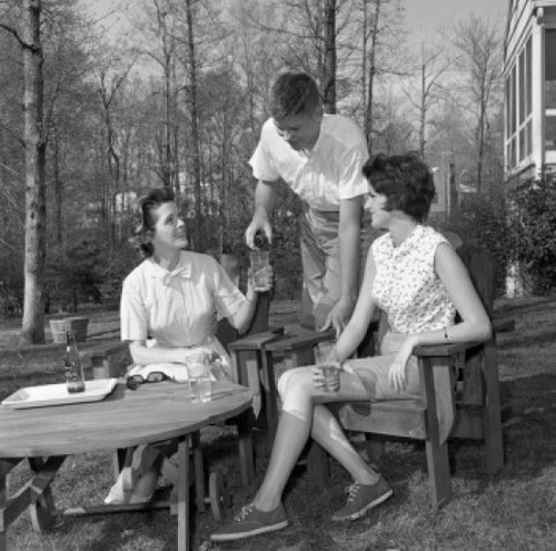 Young women and young man sitting in backyard and drinking water Poster Print - Item # VARSAL255420757