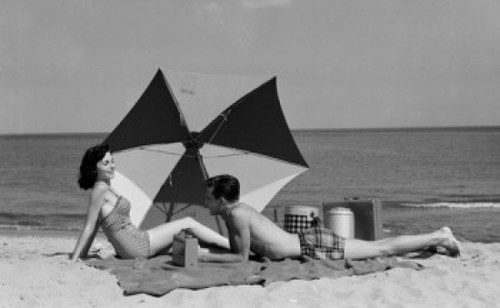 Young couple relaxing on the beach Poster Print - Item # VARSAL2558779