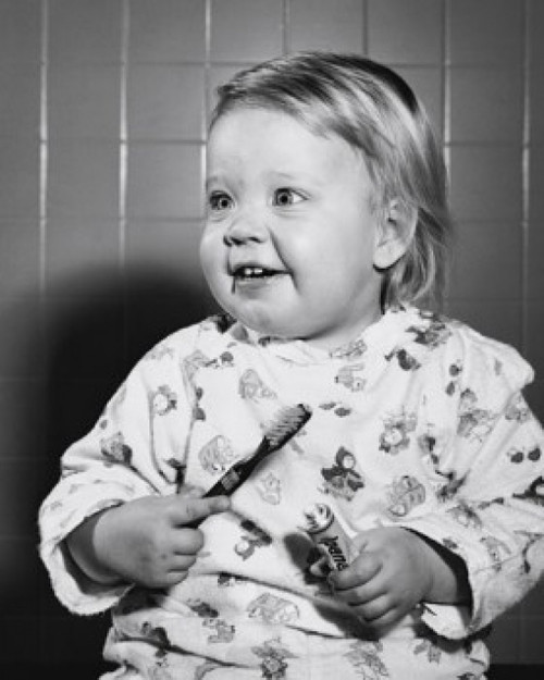 Close-up of a baby holding a toothbrush and toothpaste Poster Print - Item # VARSAL2559345