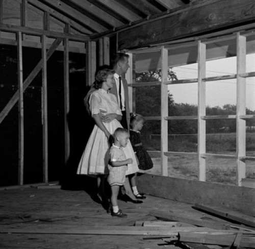 Family with son and daughter contemplating future home Poster Print - Item # VARSAL255417133