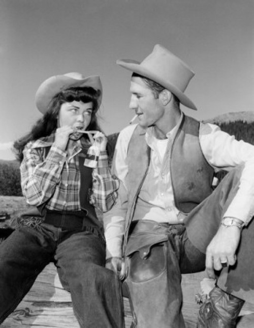 Cowgirl and cowboy sitting on fence Poster Print - Item # VARSAL255421167