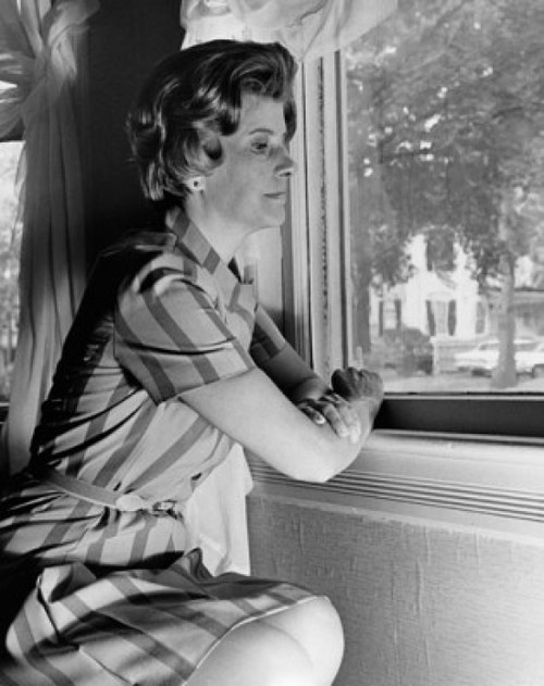 Side profile of a young woman looking through a window Poster Print