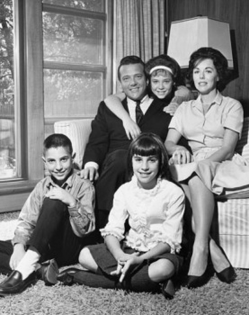 Portrait of a mid adult couple with their three children in a living room Poster Print - Item # VARSAL25517124