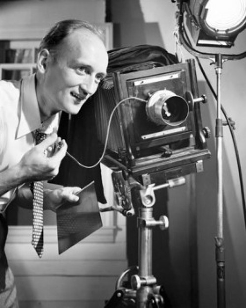 Photographer operating a camera in a studio Poster Print - Item # VARSAL2554092