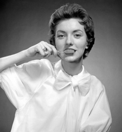 Portrait of woman cleaning teeth Poster Print - Item # VARSAL255416800