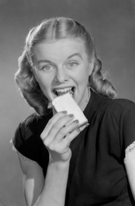Greedy young woman eating biscuit Poster Print - Item # VARSAL255418887