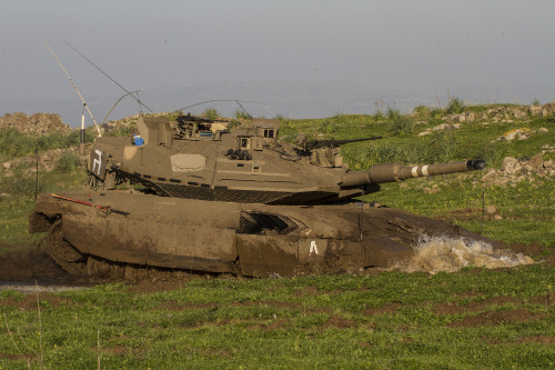 An Israel Defense Force Merkava Mark IV main battle tank driving into a mud pool during an exercise in the Golan Heights Poster Print - Item # VARPSTZDN100109M