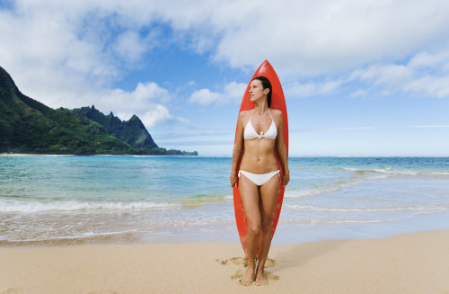 Hawaii, Kauai, Haena Beach Tunnels Beach, Woman Standing On Beach With Surfboard. PosterPrint - Item # VARDPI1966502
