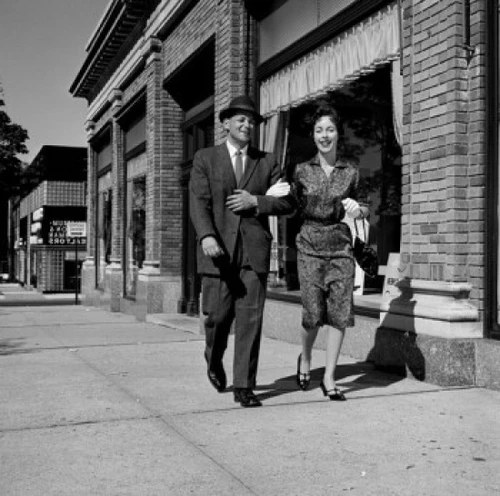 Couple walking down street Poster Print