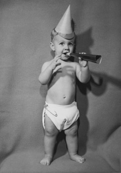 Portrait of a baby boy blowing a noisemaker Poster Print - Item # VARSAL25528974
