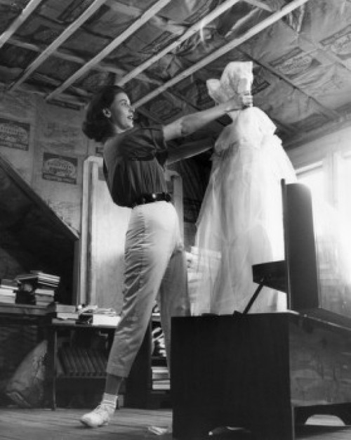 Low angle view of a young woman holding a dress Poster Print - Item # VARSAL25541886