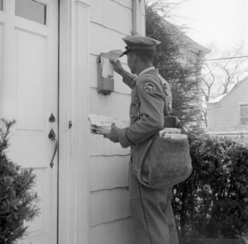 Side profile of a postman dropping mail in a mailbox Poster Print - Item # VARSAL2559605