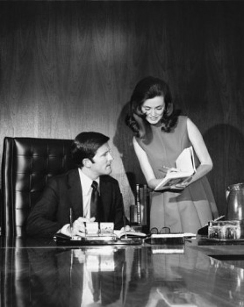 Businessman and his secretary looking at a book Poster Print - Item # VARSAL2559236