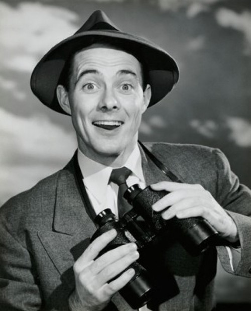 Portrait of a young man smiling and holding binoculars Poster Print - Item # VARSAL25535666