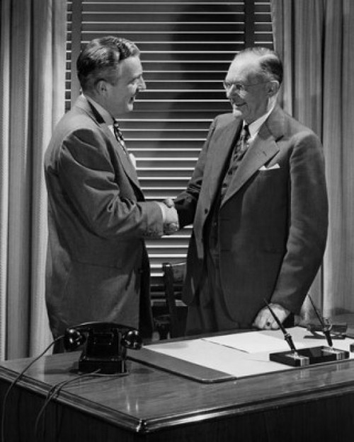Two businessmen shaking hands Poster Print