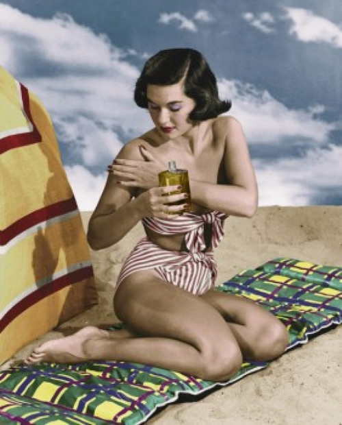 Young woman applying suntan lotion on beach Poster Print - Item # VARSAL25518814A