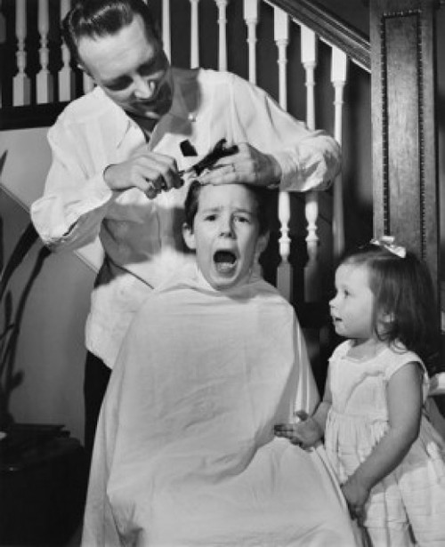 Father cutting his son's hair Poster Print