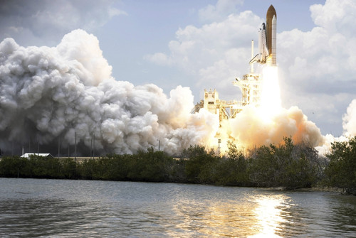 Space Shuttle Atlantis lifts off from its launch pad toward Earth orbit Poster Print