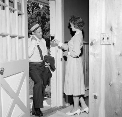 Woman giving husband drink at front door Poster Print - Item # VARSAL255417619 Woman giving husband drink at front door Poster Print - Item # VARSAL255417619