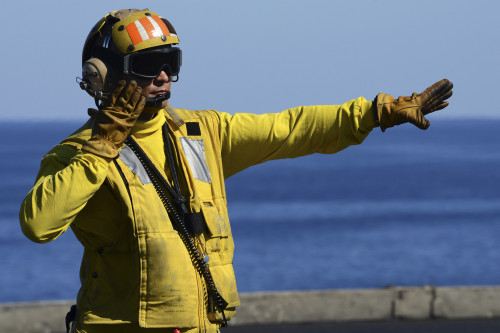 February 8, 2013 - Aviation Boatswain's Mate directs an aircraft on the flight deck of the aircraft carrier USS John C. Stennis Poster Print - Item # VARPSTSTK106795M