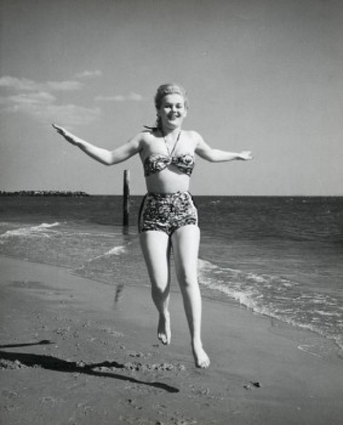 Portrait of a young woman running on the beach Poster Print - Item # VARSAL25511214