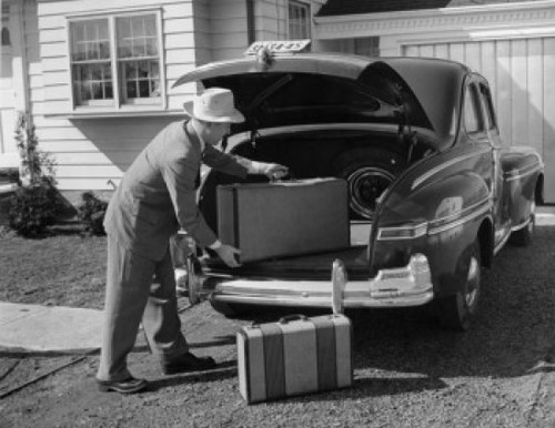Side profile of a mature man loading a suitcase into the trunk of a car Poster Print - Item # VARSAL25519022