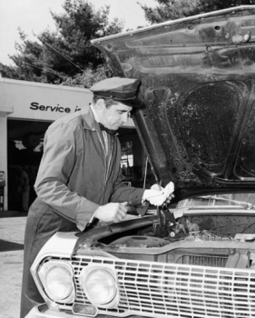 Auto mechanic repairing a car at a service station Poster Print - Item # VARSAL2554343