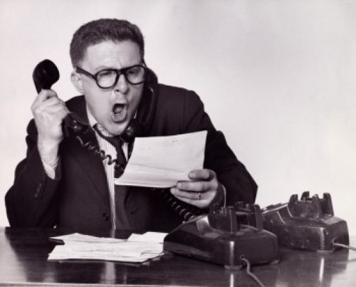 Close-up of a businessman using two telephones Poster Print - Item # VARSAL2554069