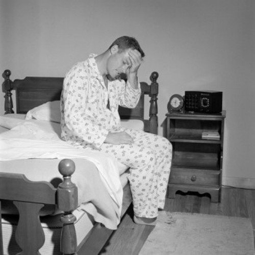 Man with headache  sitting on bed Poster Print - Item # VARSAL255417622